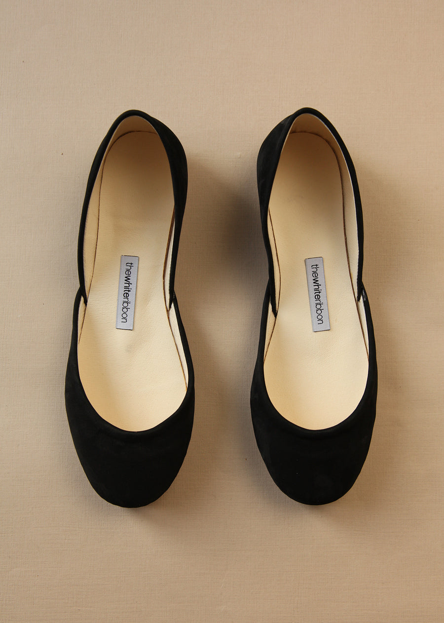 black leather ballerinas from top shot with light background