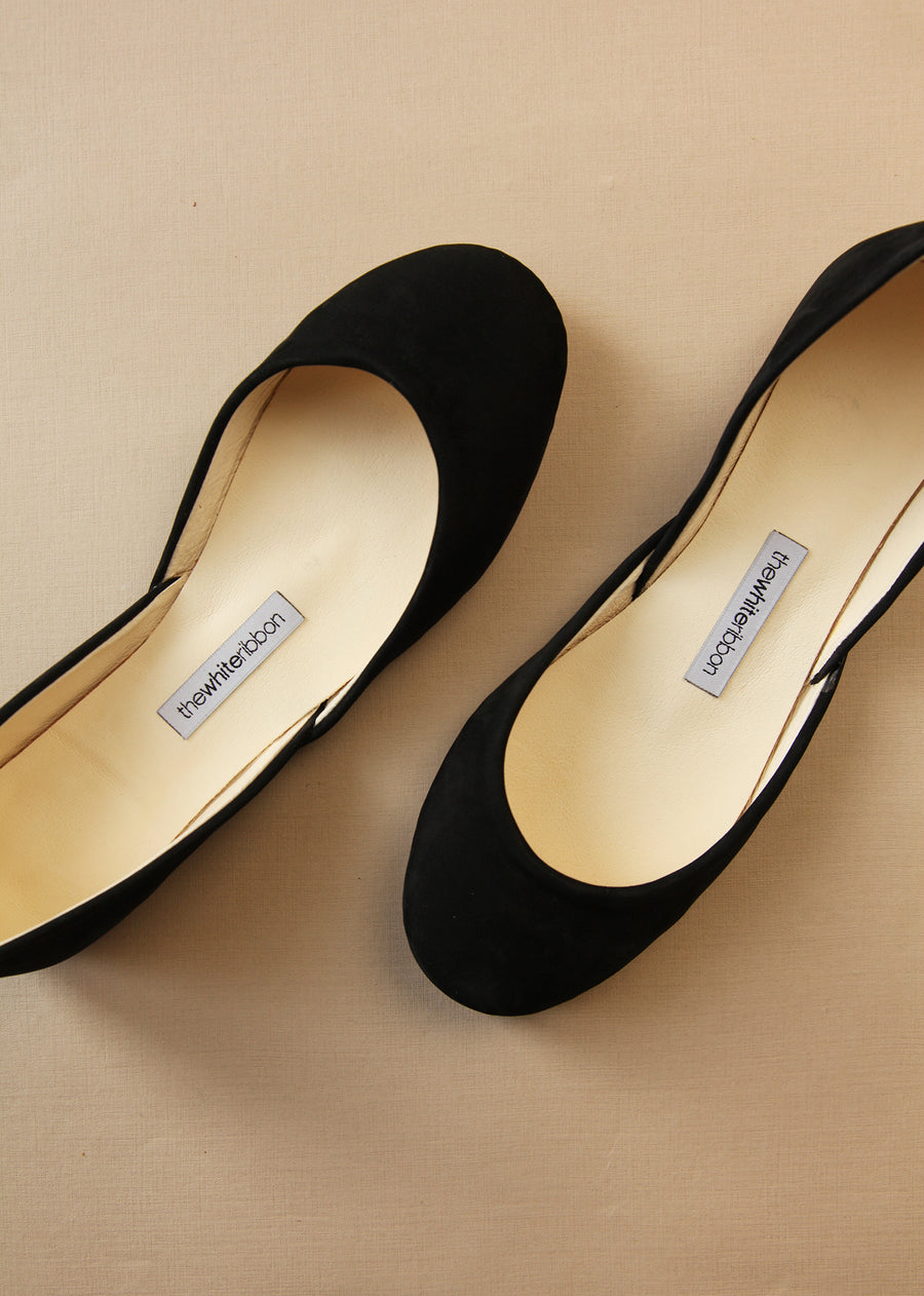 black nubuck ballerinas from above with white background