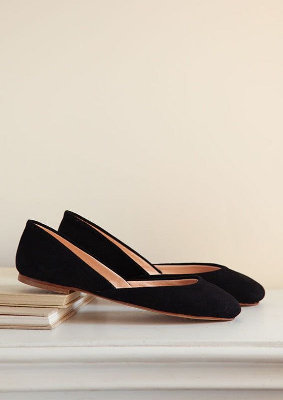 a pair of black nubuk leather ballet flats side view 